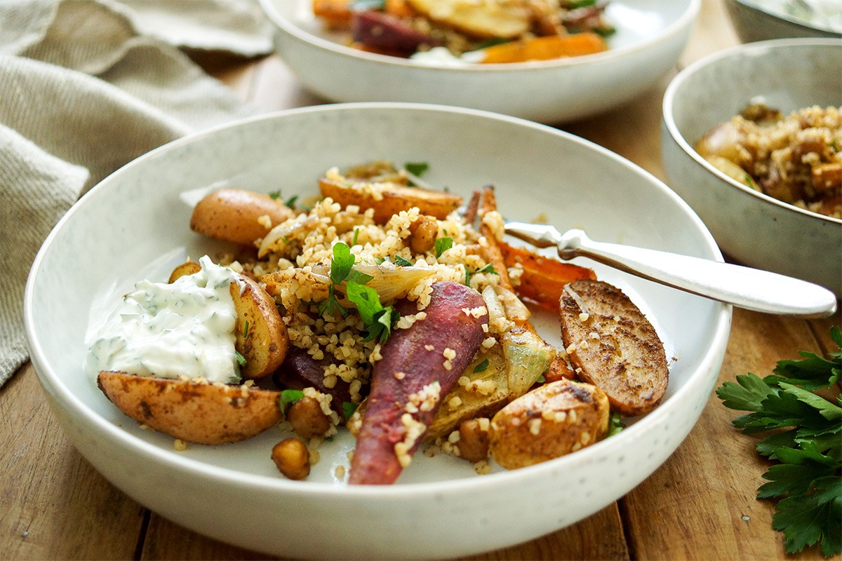 Baked sweet potato with roasted vegetables and bulgur wheat