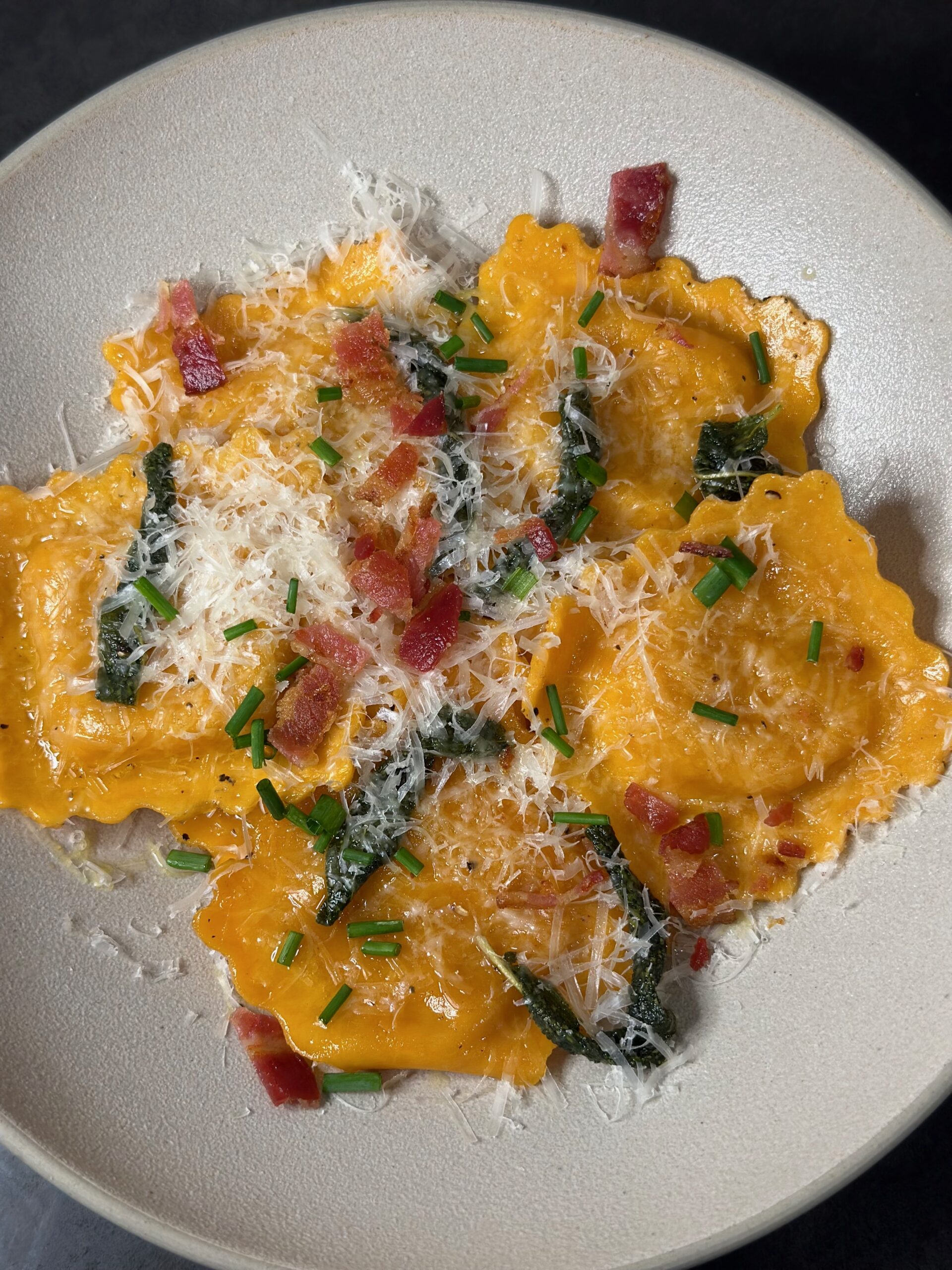 Butternut squash ravioli with fried sage leaves and sun-dried tomatoes